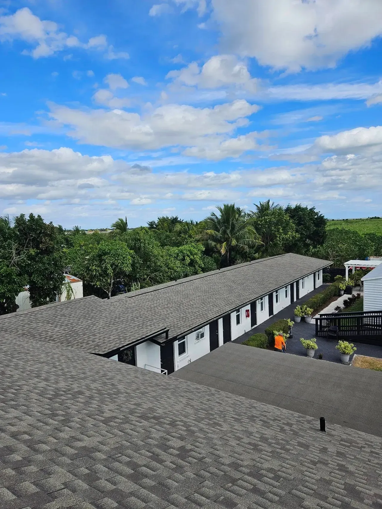 An aerial view of a row of buildings with a roof that is covered in shingles.