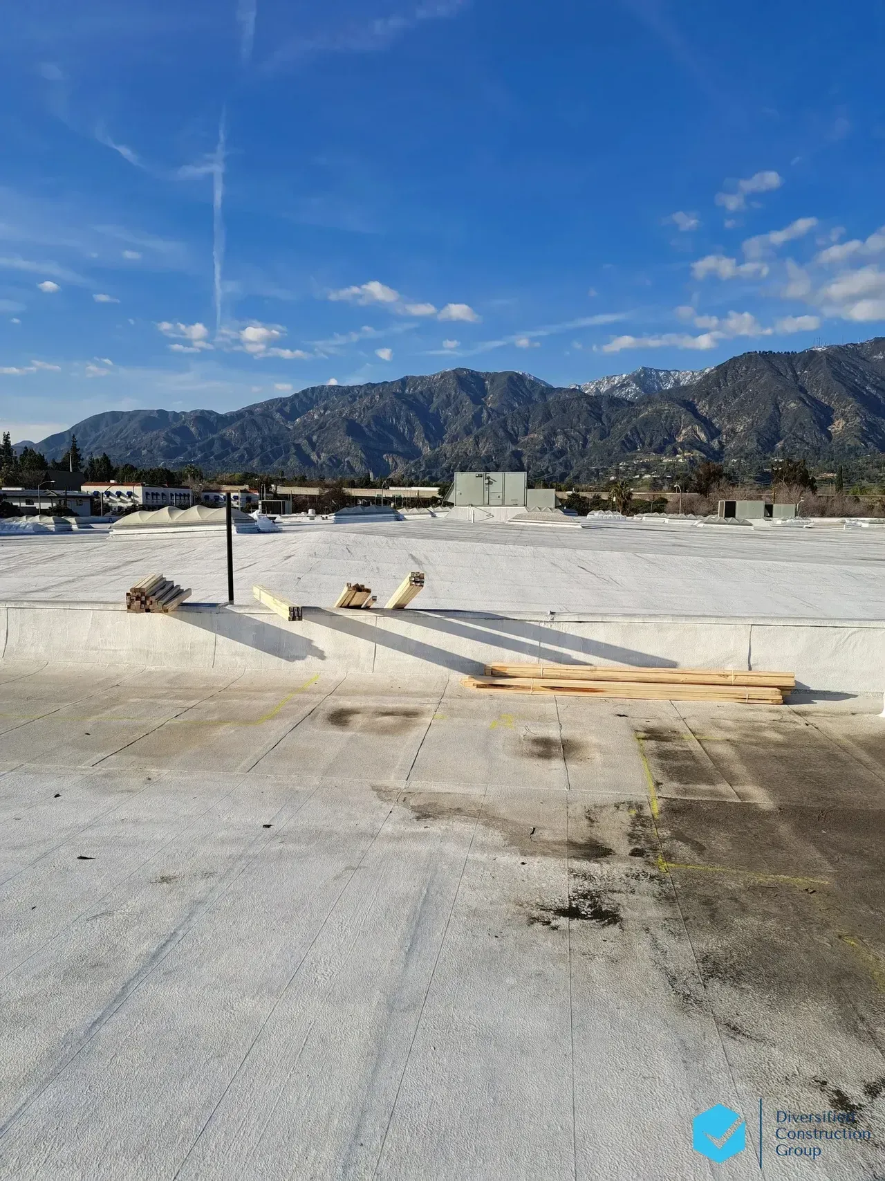 Buckets of paint are sitting on top of a metal roof.