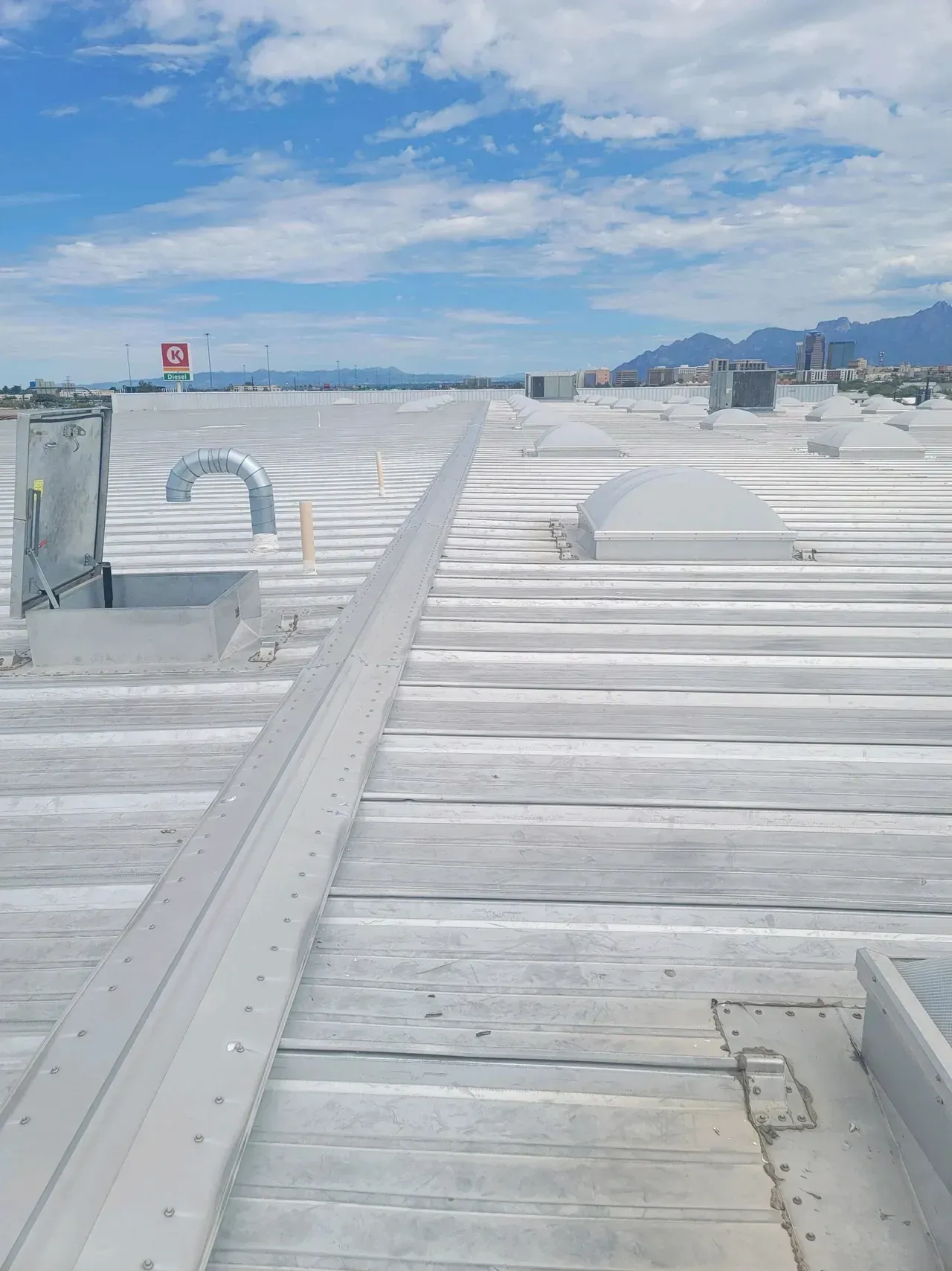 A large white roof with a blue sky in the background.