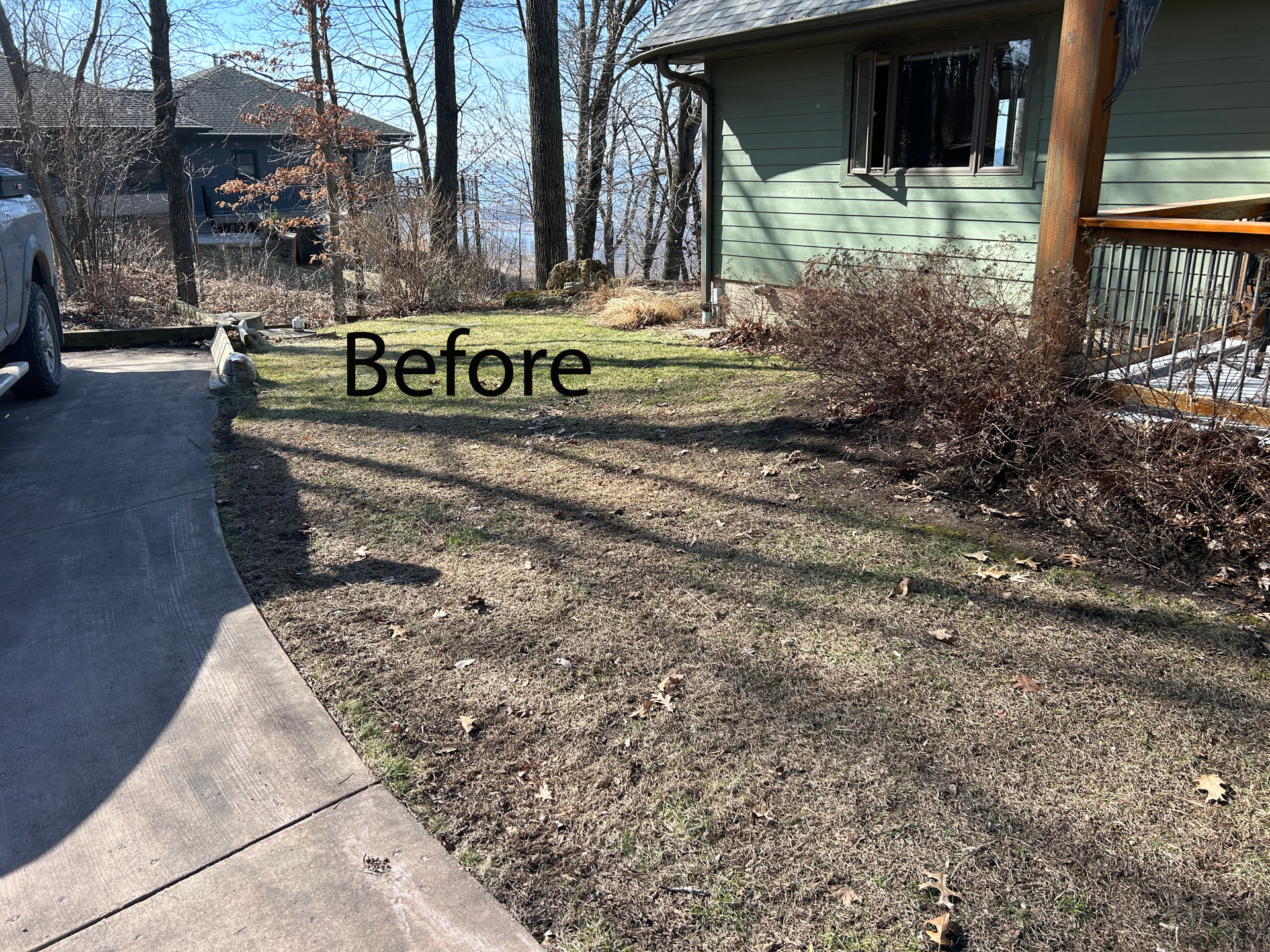Front yard with patchy grass and a curved driveway beside a green house, labeled “Before.”