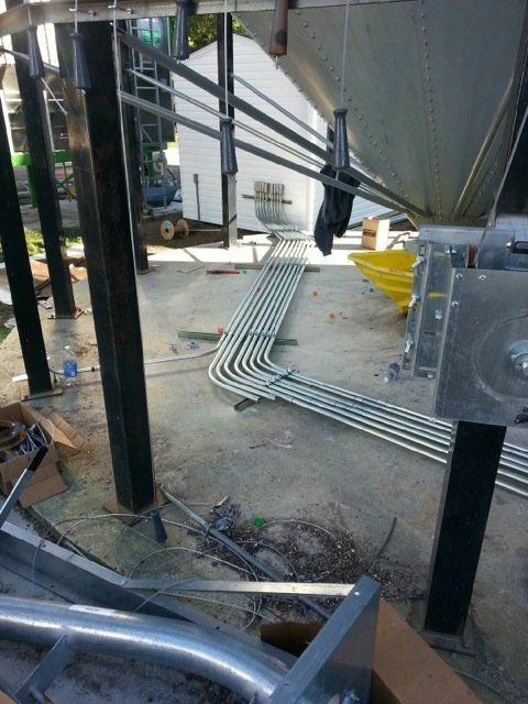 A bunch of metal pipes are laying on the ground