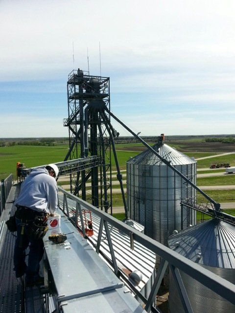 A man is working on the roof of a building