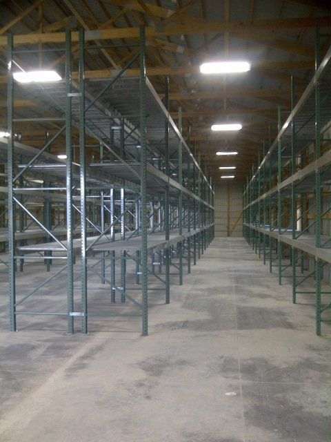 A large warehouse with lots of shelves and tables