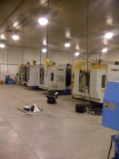 A row of machines are lined up in a large room