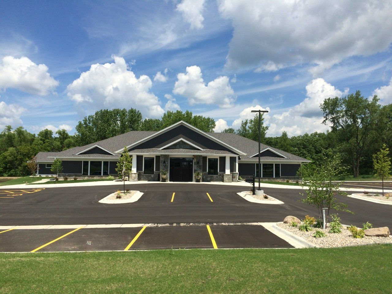 A large building with a parking lot in front of it.
