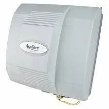 Aprilaire whole-house humidifier, light gray with the brand name on the front.