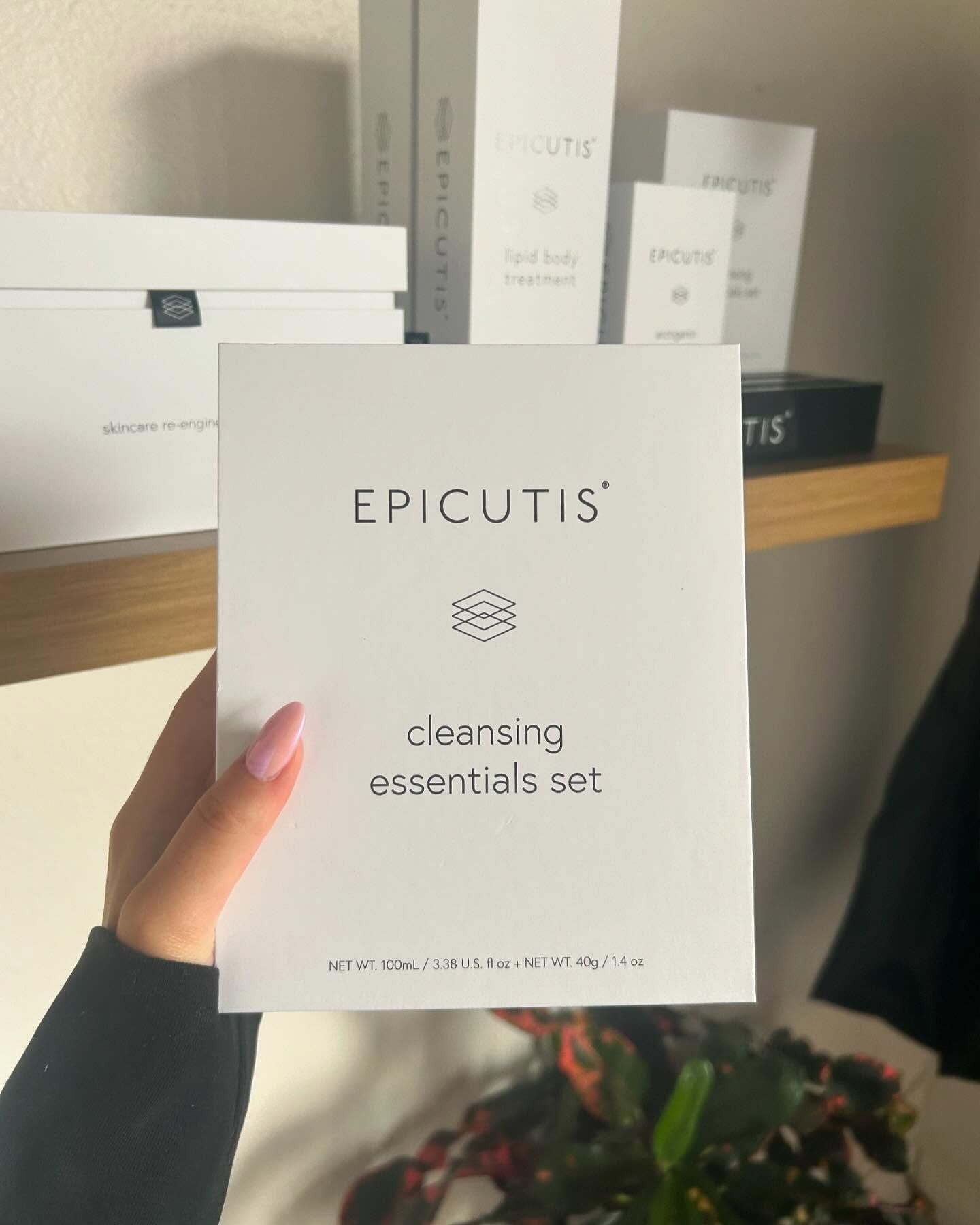 A person is holding an epicutis cleansing essentials set
