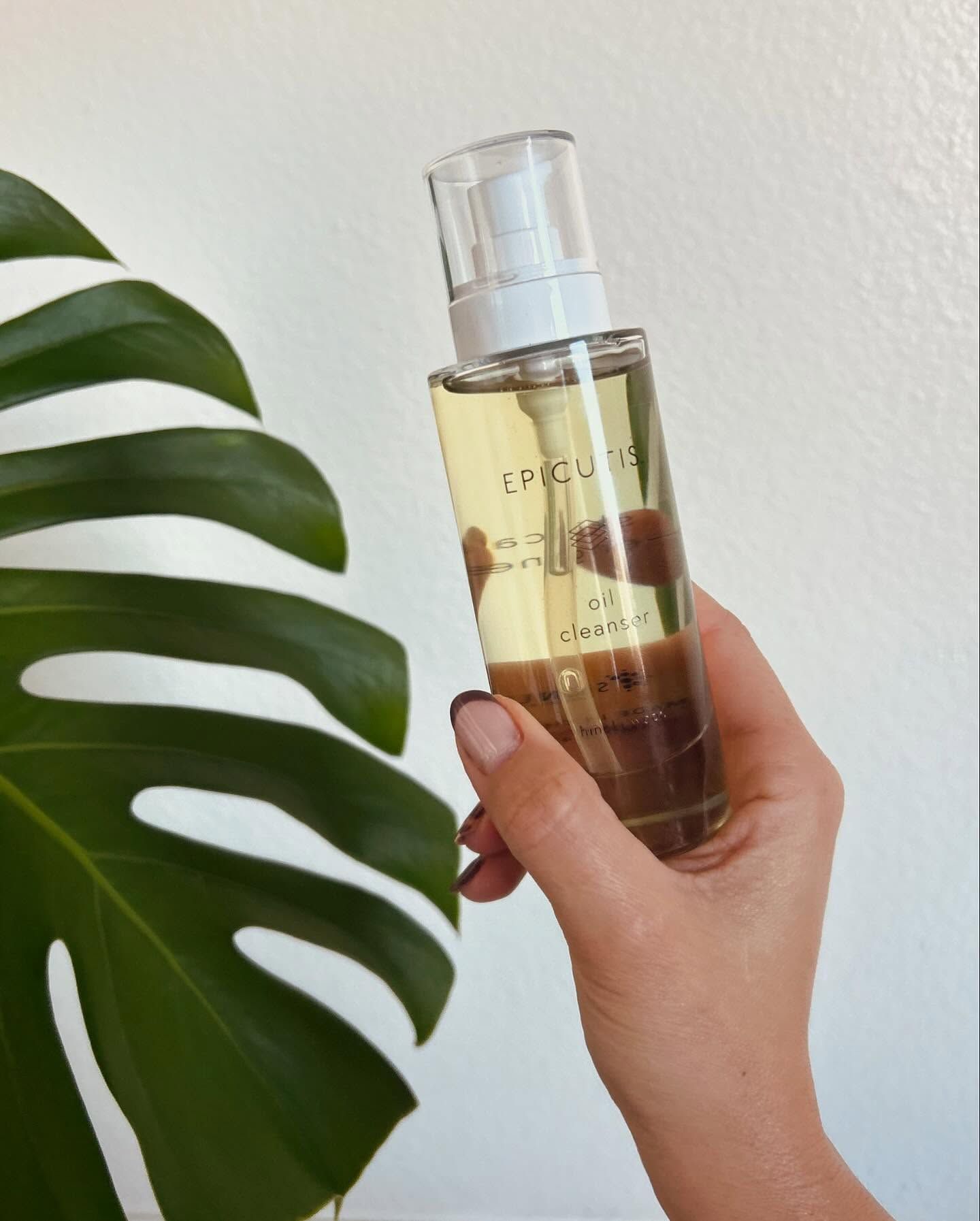 A person is holding a bottle of epic perfume