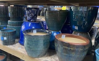 Stacked blue and gray ceramic planters on store shelves