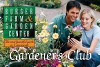 Florist holding a basket of colorful flowers; wearing an apron with sunflower design; smiles.
