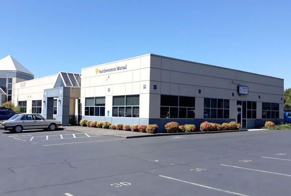 a car is parked in front of a large building