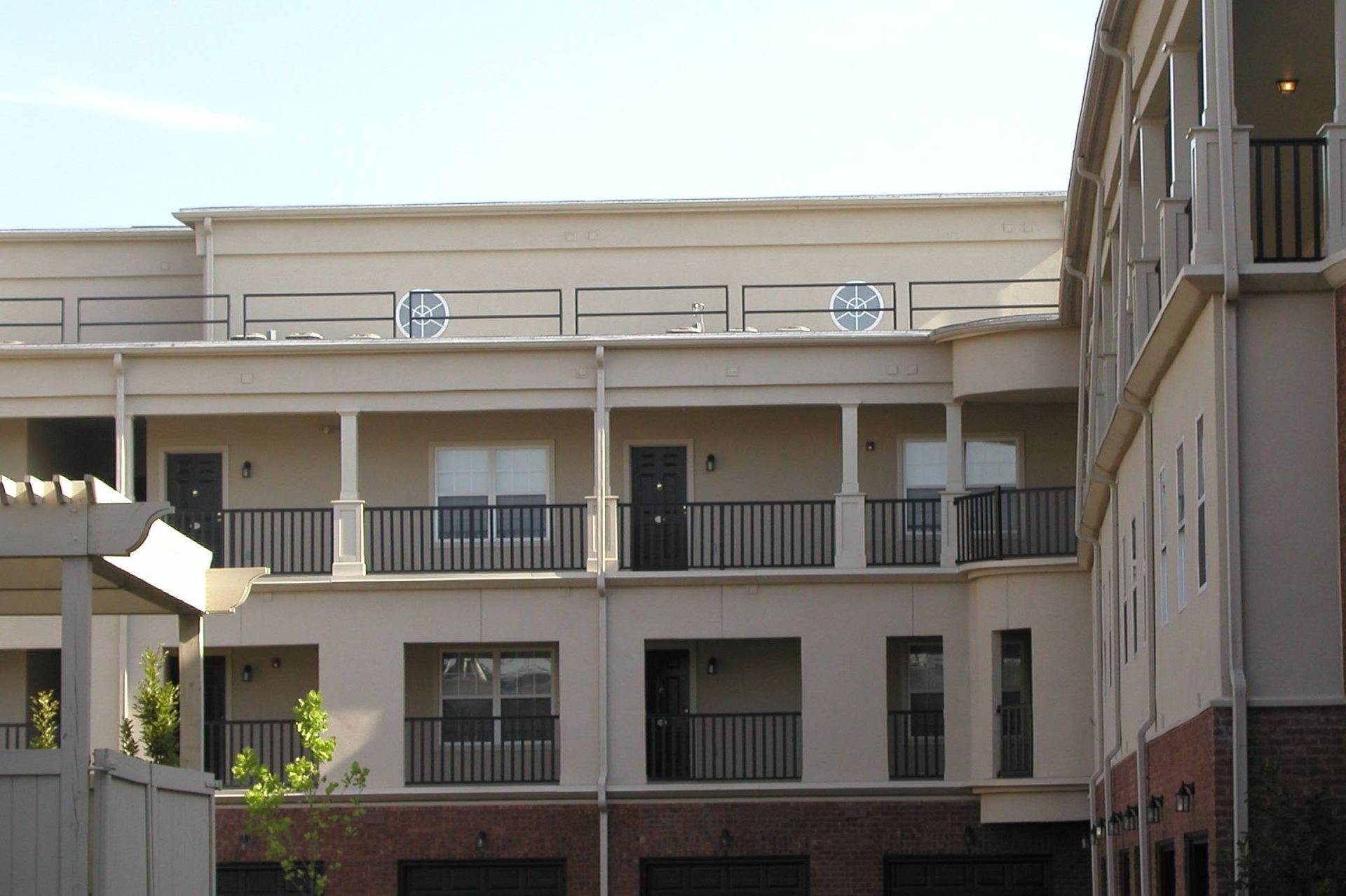 Apartment courtyard with cream balconies and windows under a clear sky