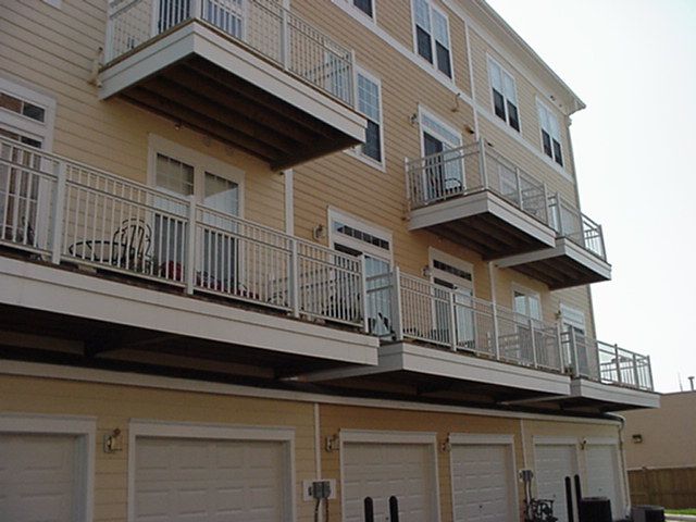 Apartment building exterior with balconies and garage doors