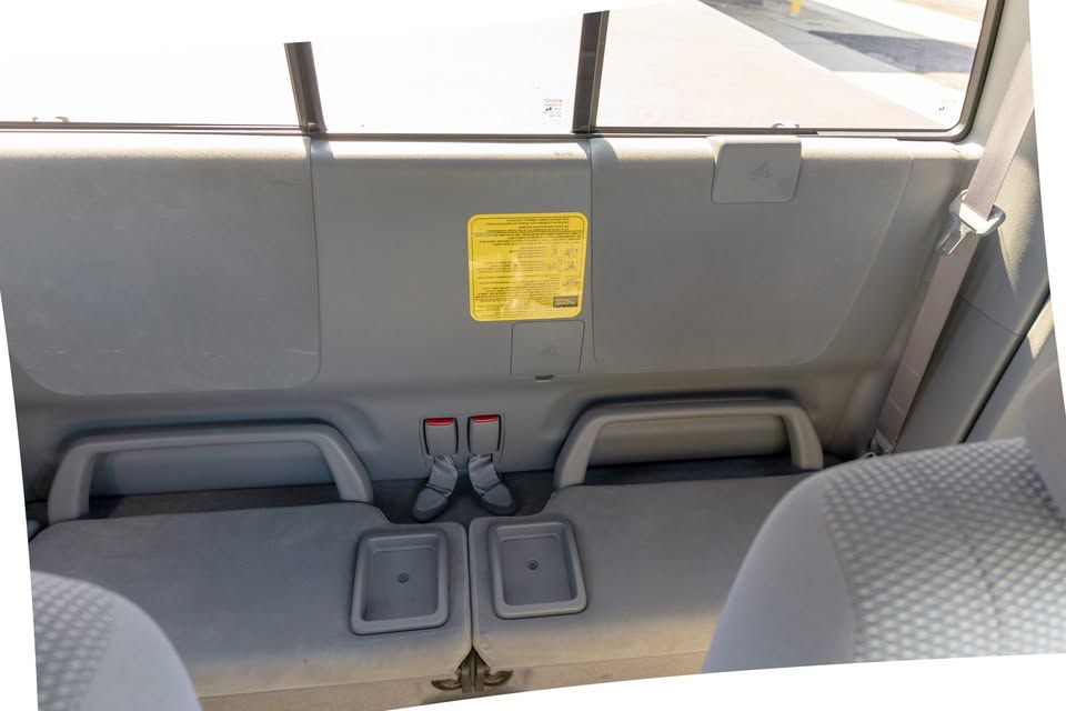 The back seat of a car with a yellow sticker on it.