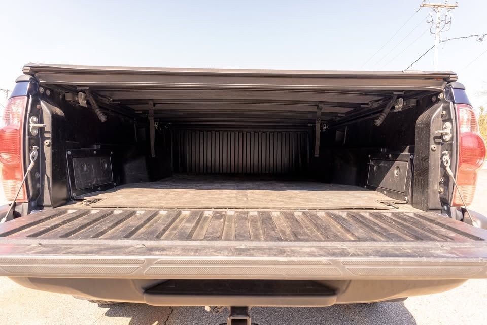 The back of a truck with the bed open.