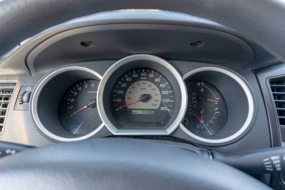 A close up of a car dashboard with a speedometer and a tachometer.