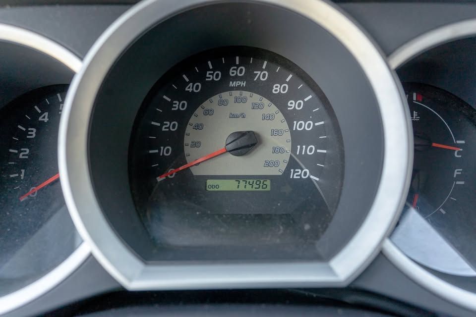 A close up of a car 's speedometer with the number 120 on it
