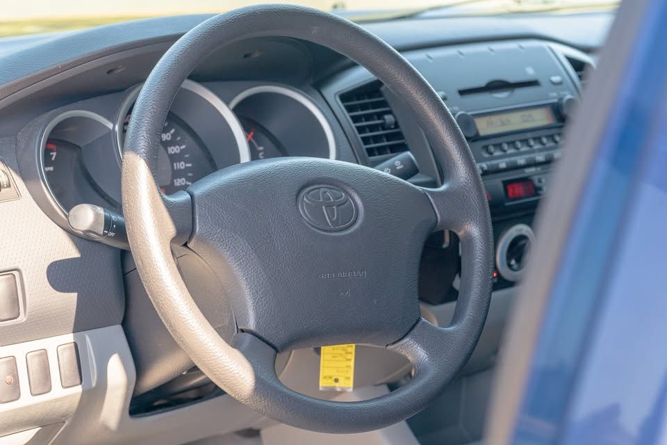 A close up of the steering wheel of a toyota truck
