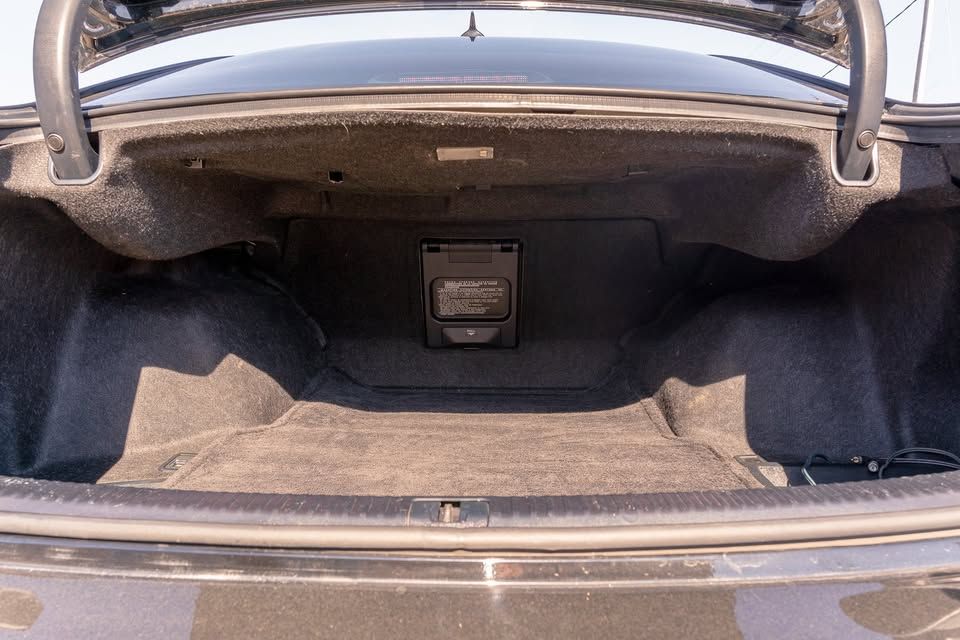 The trunk of a car is open and empty.