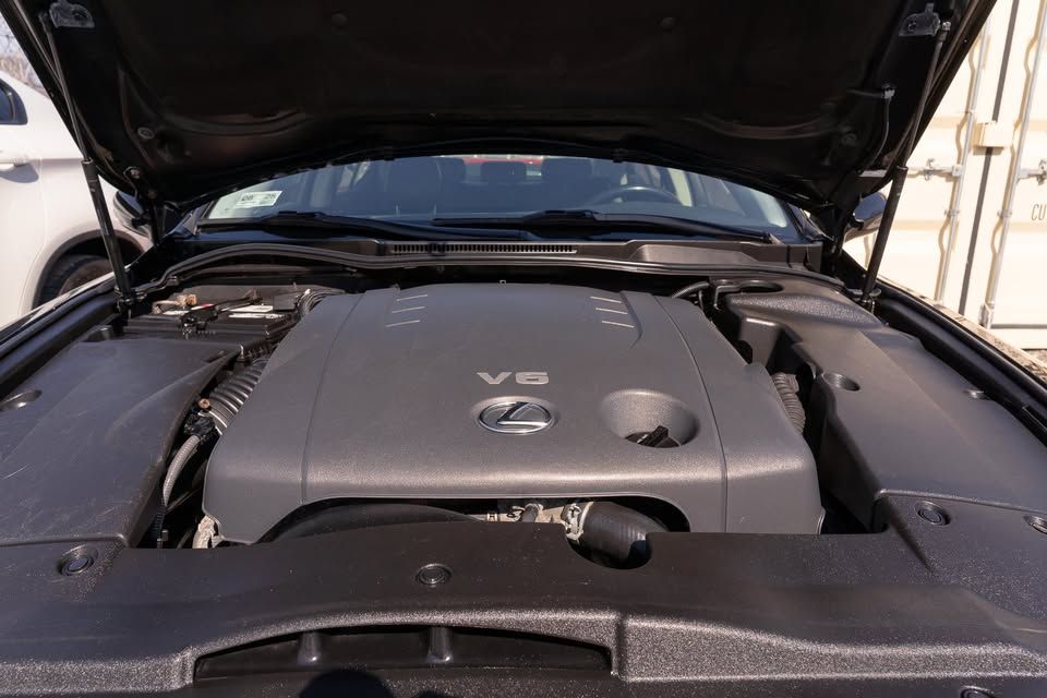 The engine of a black car with the hood open