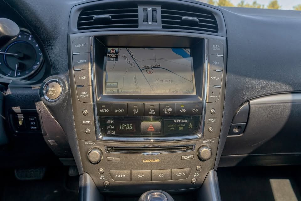 A close up of the dashboard of a car with a navigation system.