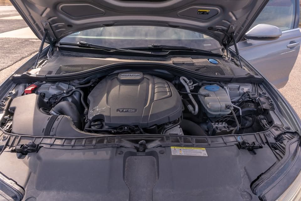 The engine of a car is shown with the hood open.