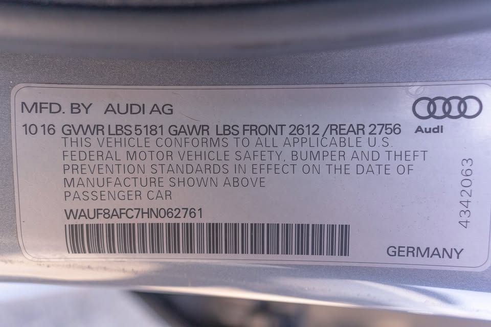 A close up of a sticker on a car that says mfd by audi ag