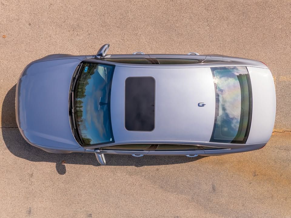 An aerial view of a silver car with a sunroof.