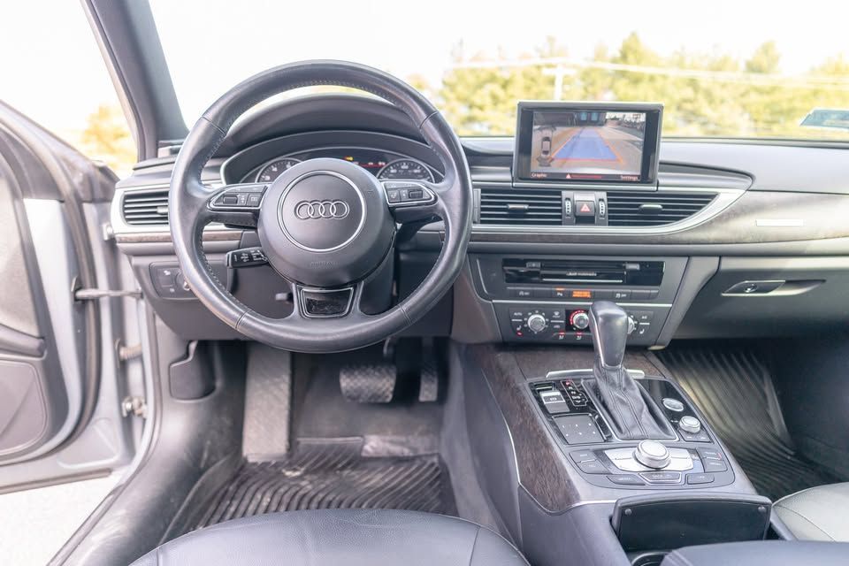 The interior of a car with a steering wheel and dashboard.