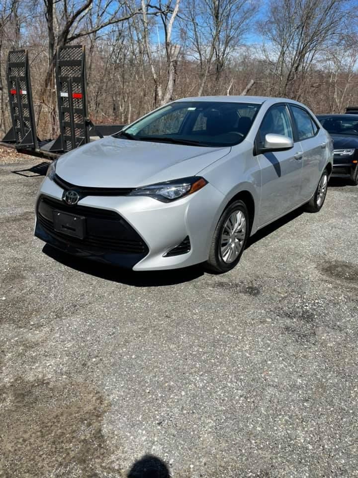 A silver Toyota vehicle is parked in a parking lot