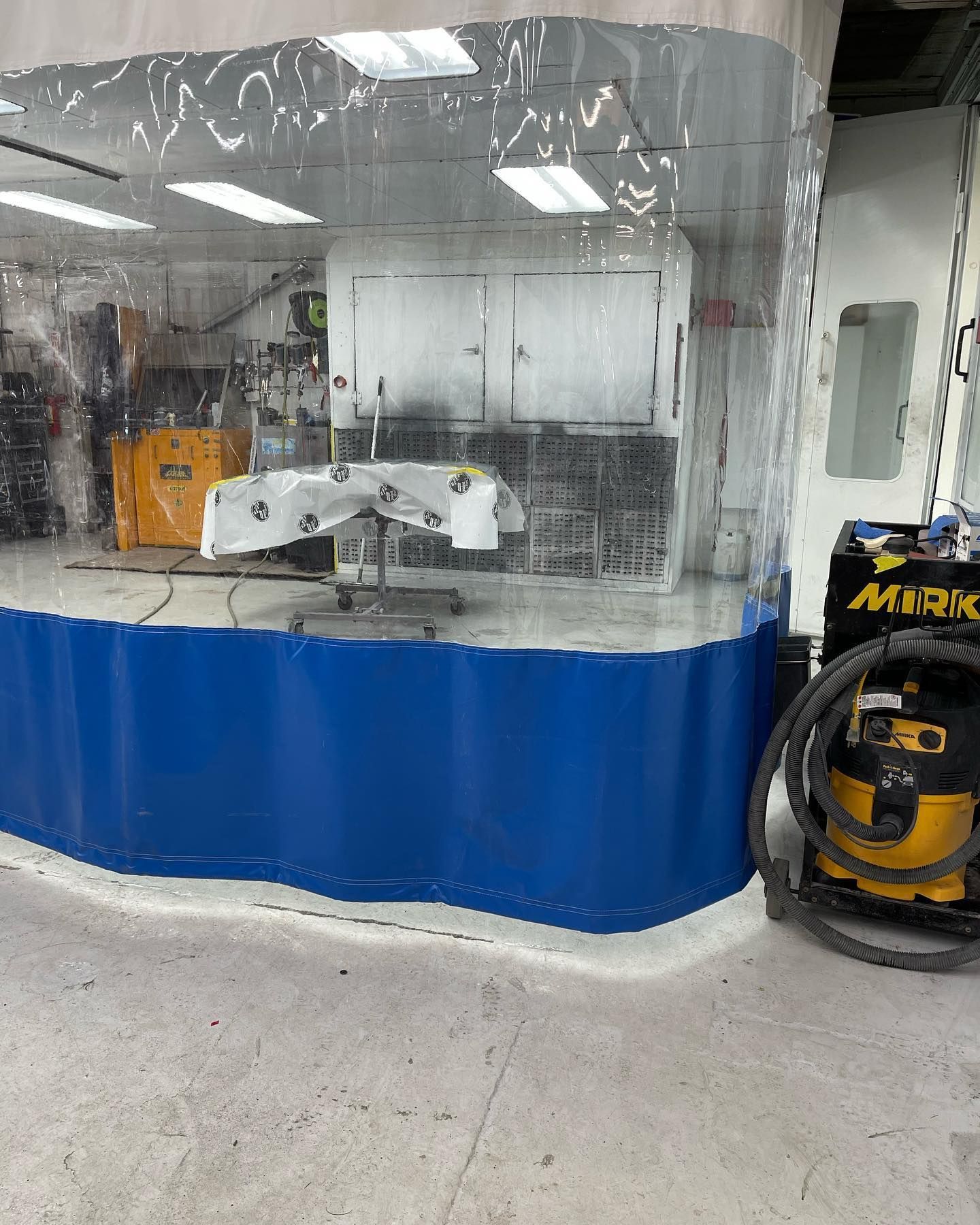 A curtained space in the auto body shop