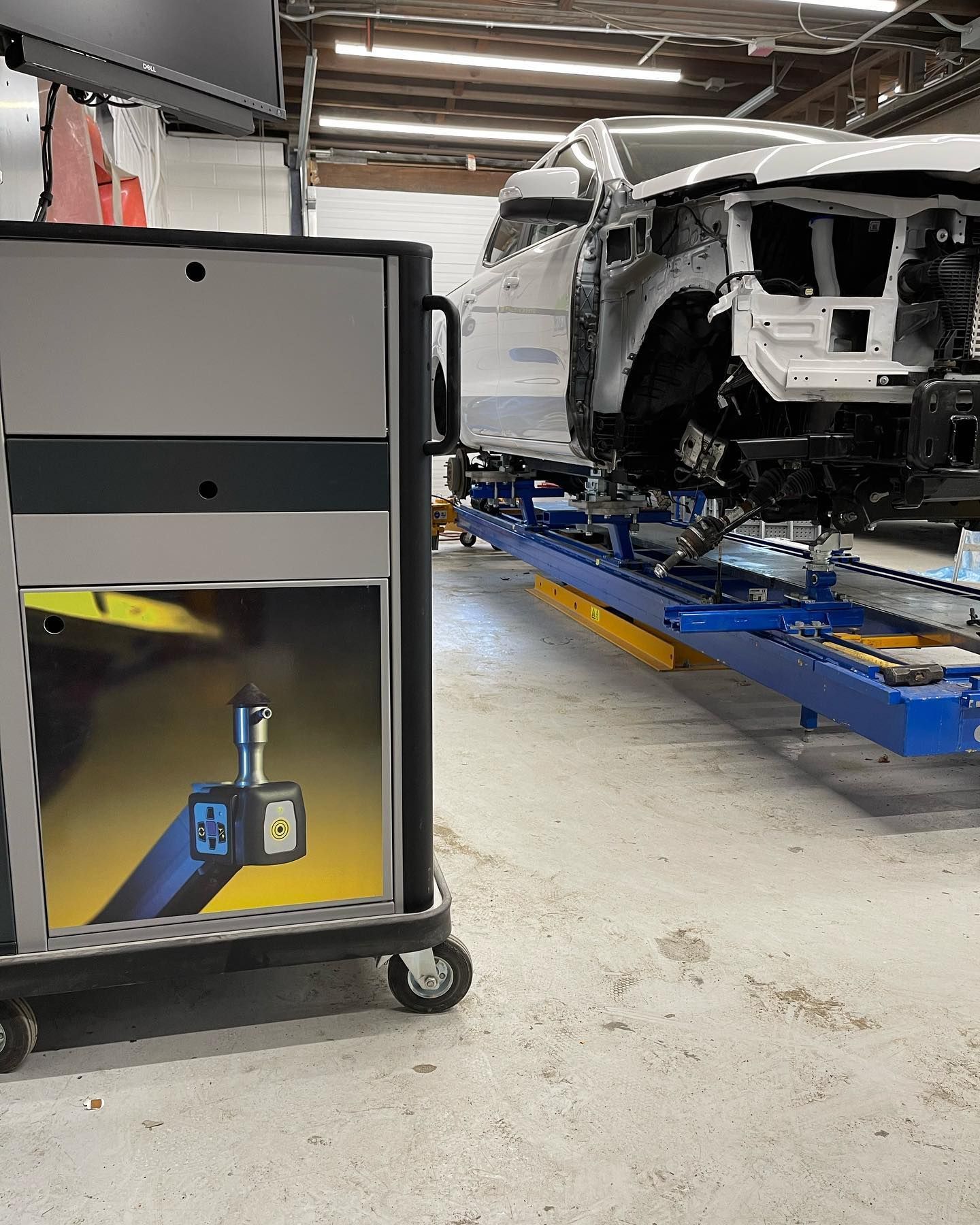 A car is being worked on in an auto body shop