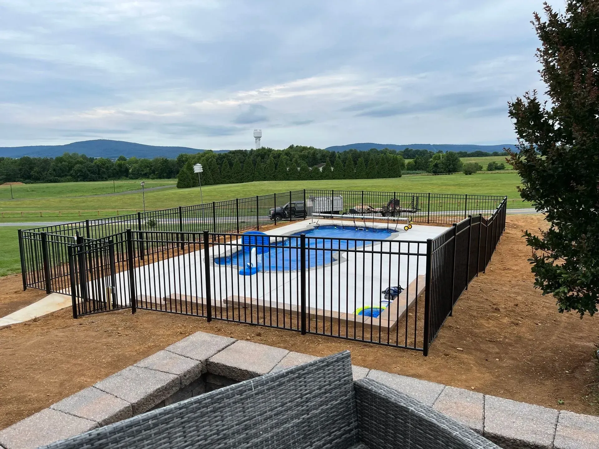 A large swimming pool surrounded by a metal fence.