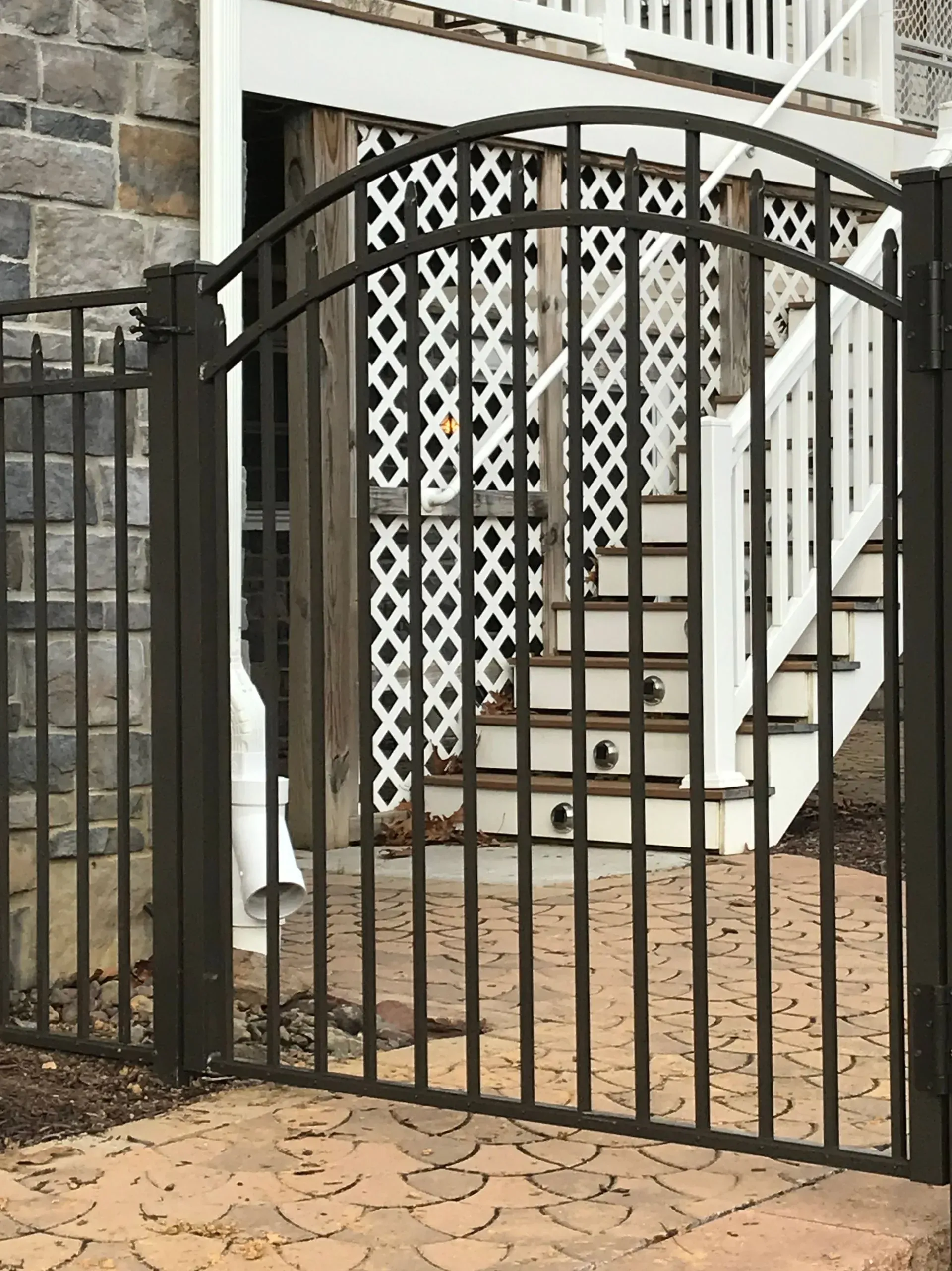 A wrought iron gate with stairs in the background