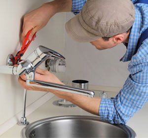 plumber installing new faucet