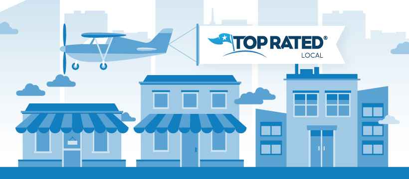 An airplane with a banner flies over a row of businesses. The banner reads