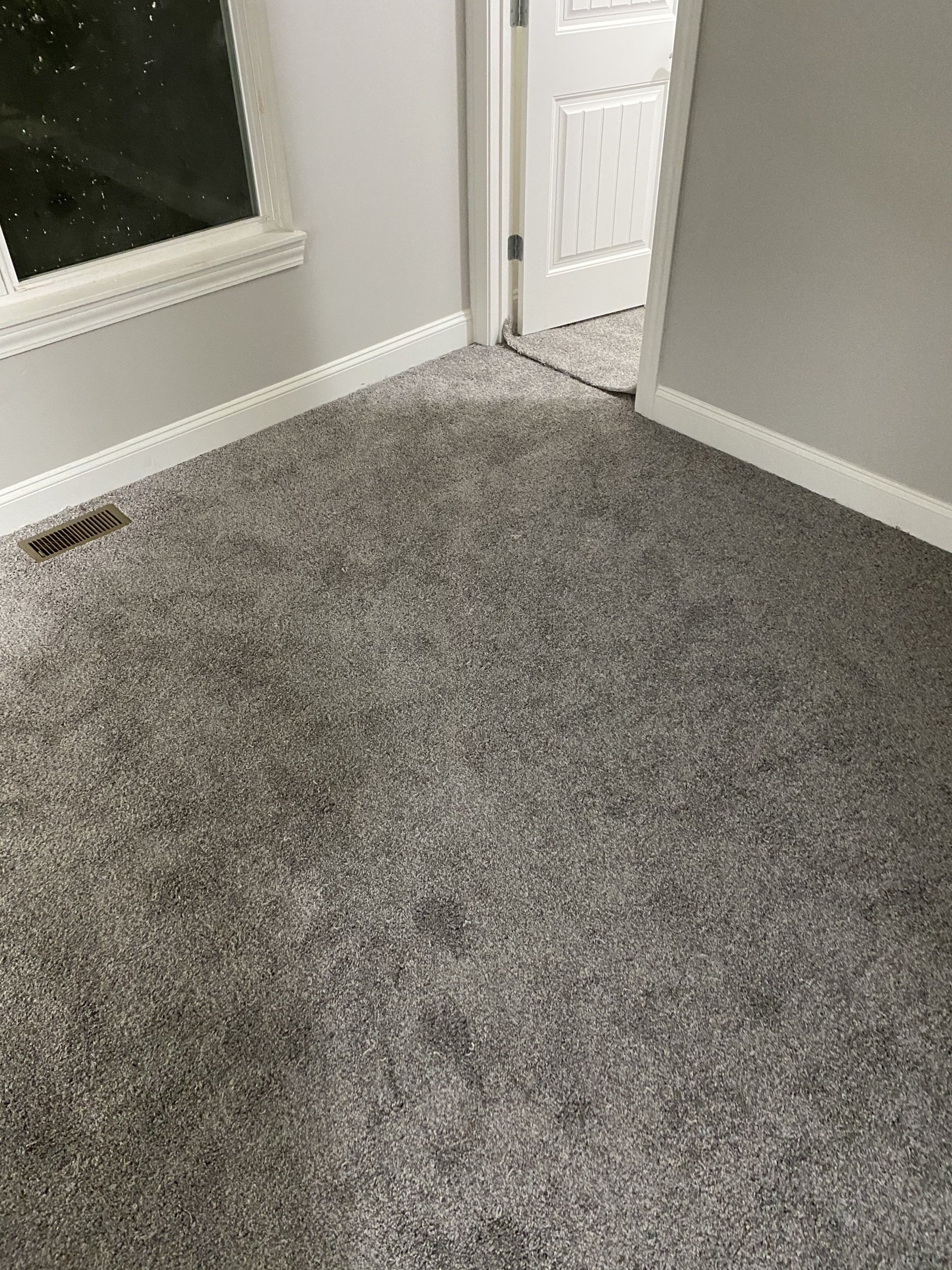 Room with gray carpet, white trim, and a doorway.