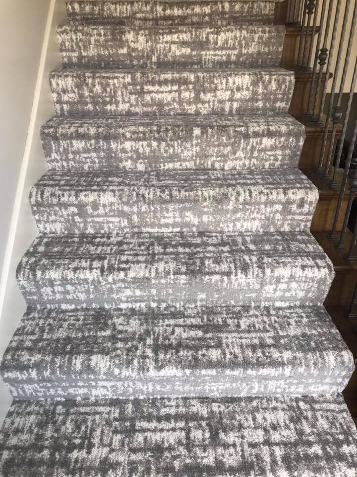 Sandy dunes with long, curved shadows. Warm brown and purple tones.