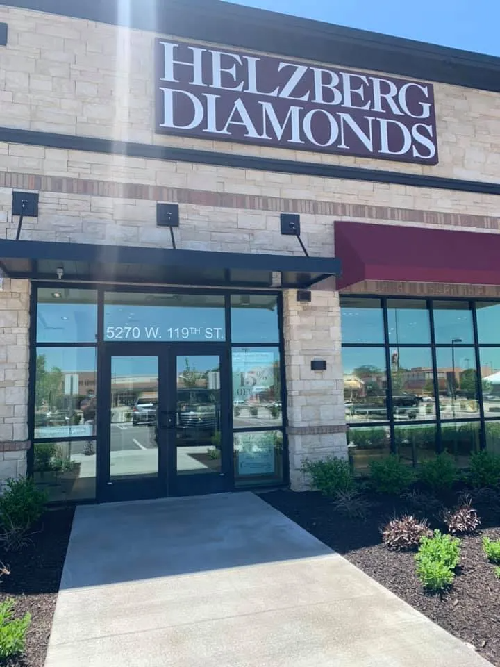 Helzberg Diamonds store exterior with sign; stone facade, glass windows, blue sky.