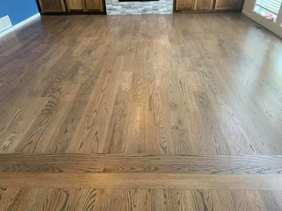 Wooden floor with medium brown stain, in a well-lit interior space.