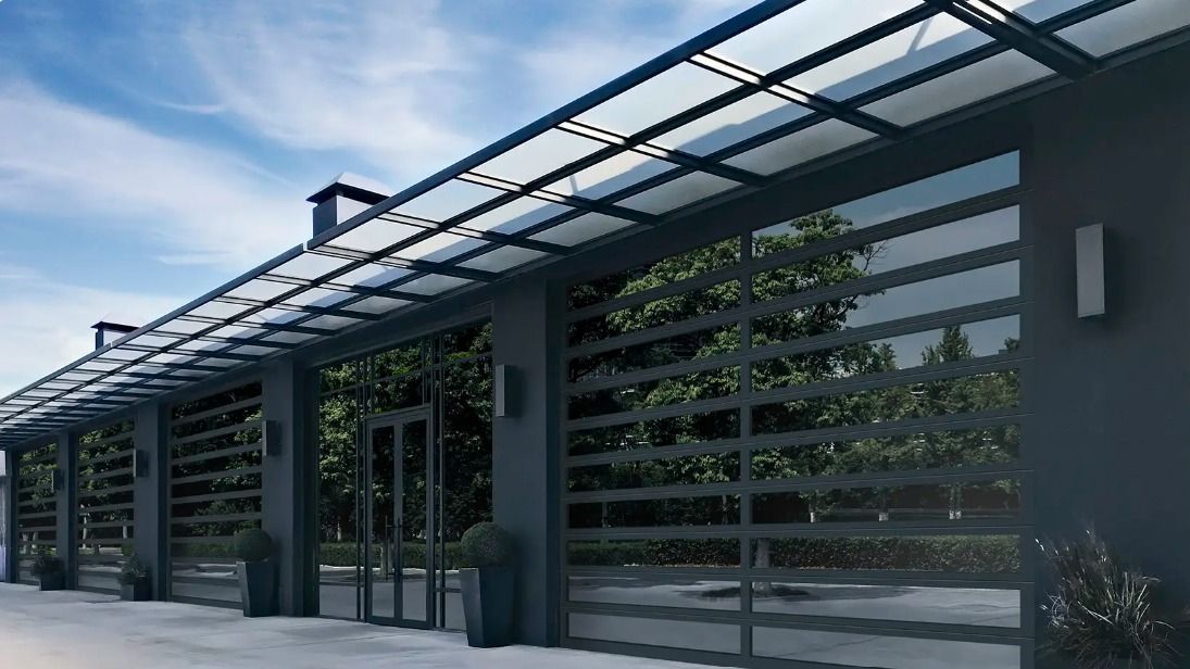 Modern building facade with glass awning, horizontal slats, and potted plants along a walkway