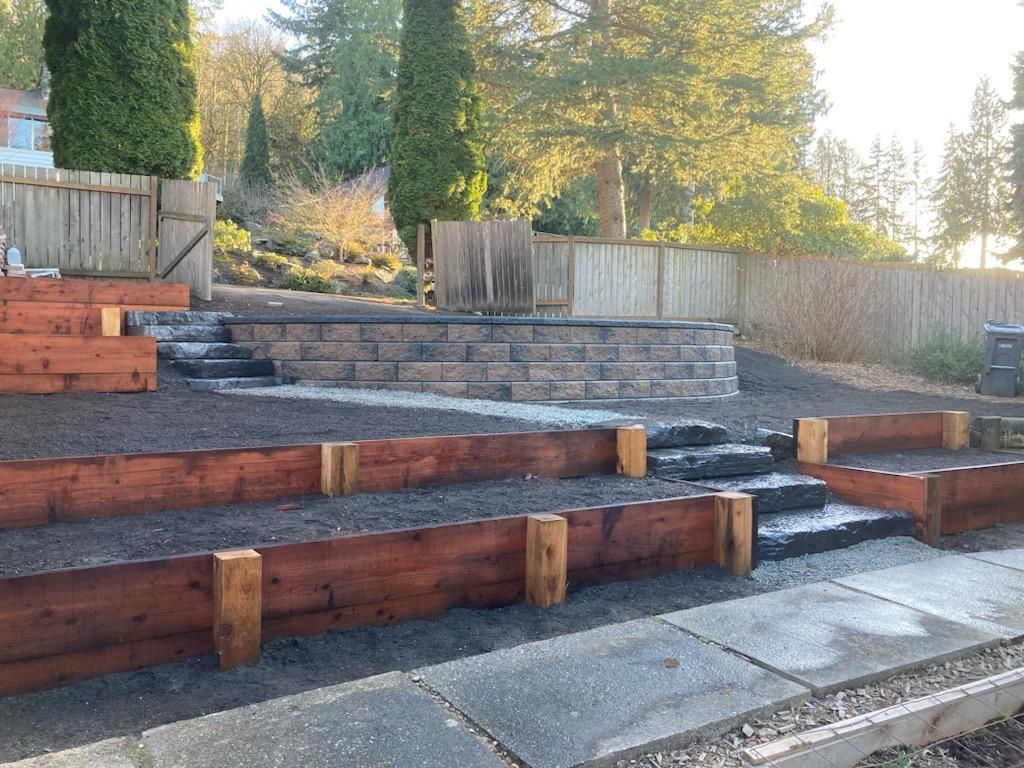 A wooden fence and stairs are being built in a backyard.