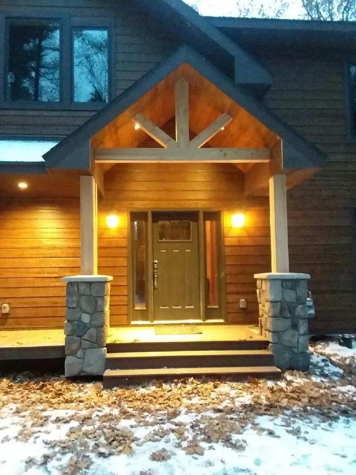 the front of a house with a porch and stairs
