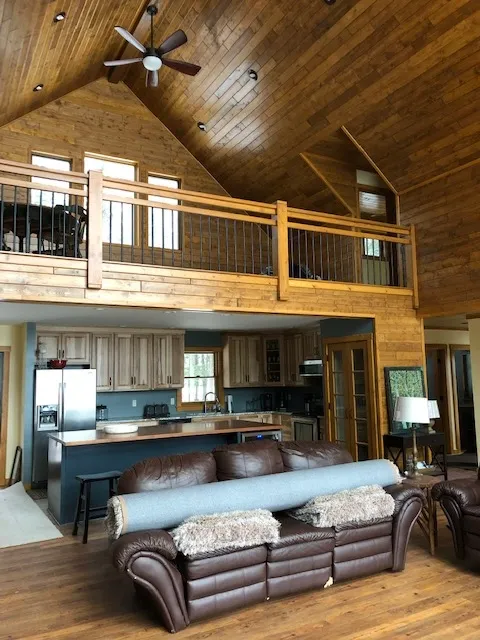 a living room with a couch and a ceiling fan
