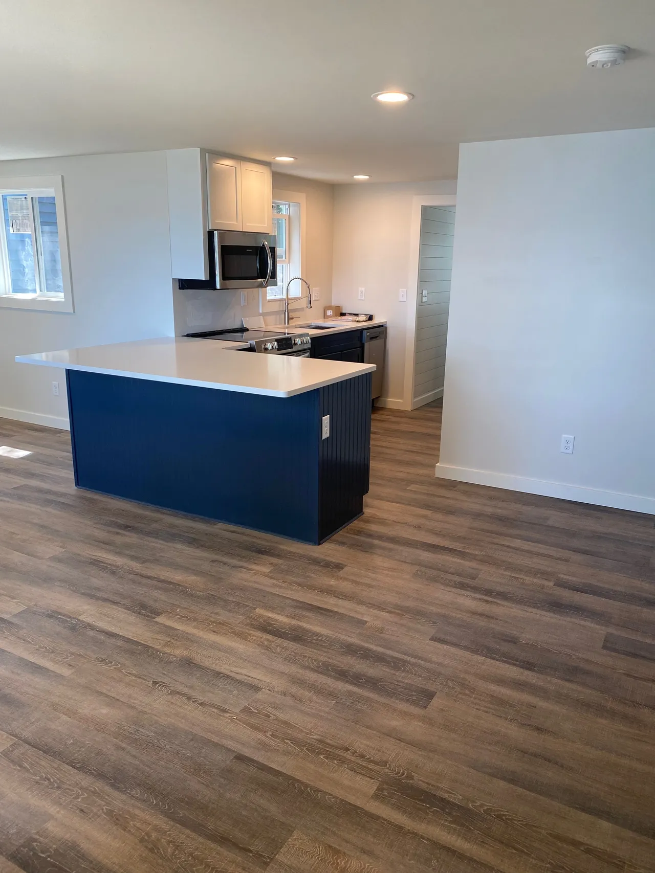 a kitchen with a blue island in the middle of the room