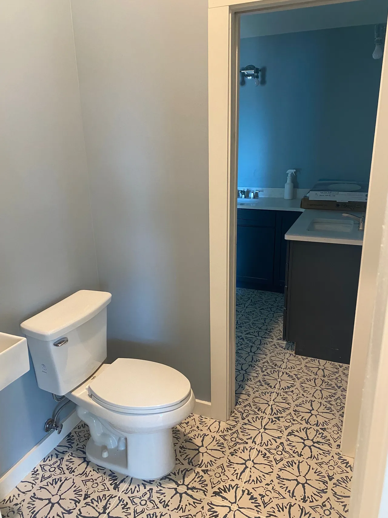 a toilet is sitting in a bathroom next to a sink