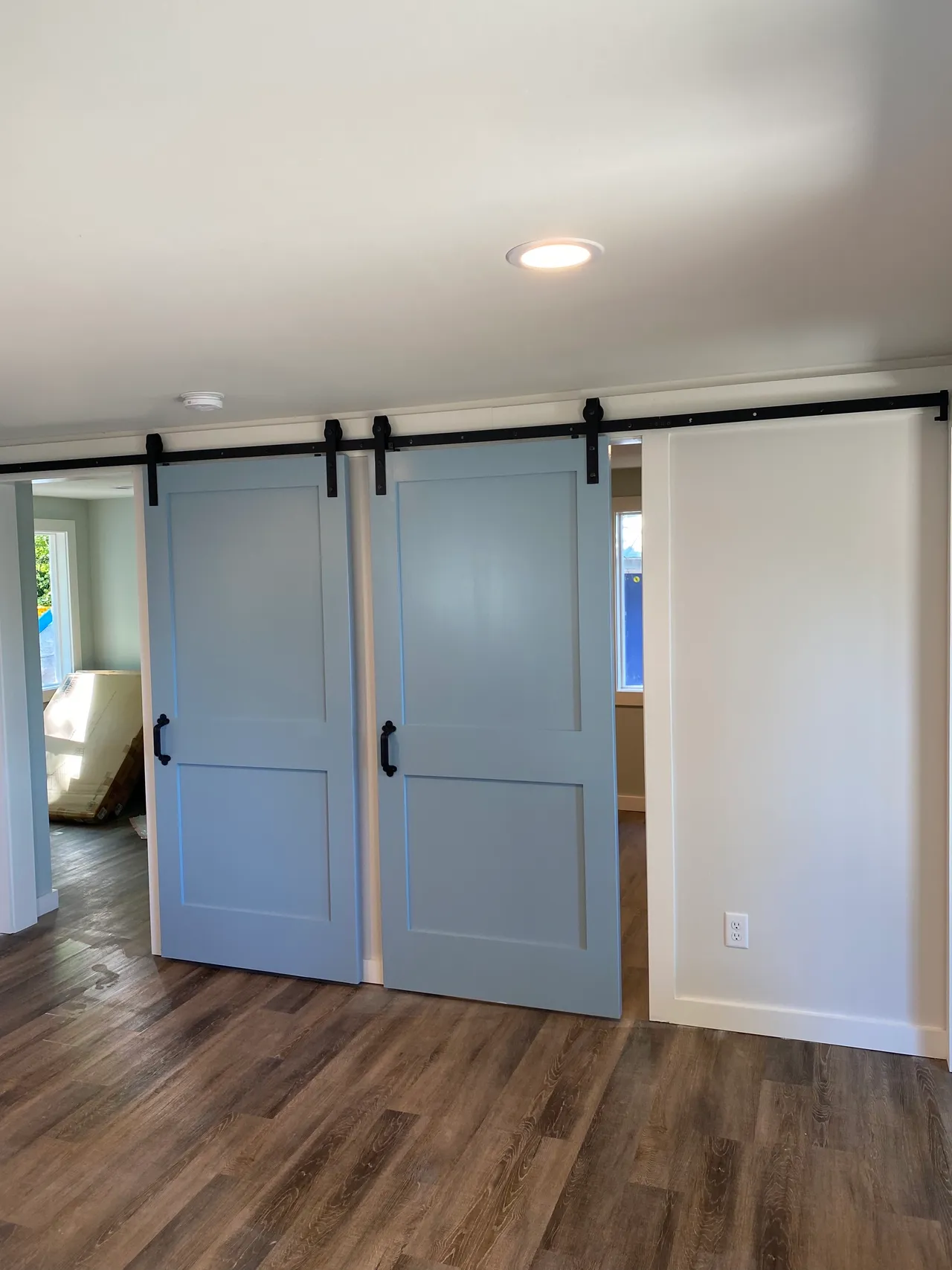 there are three sliding barn doors in the room