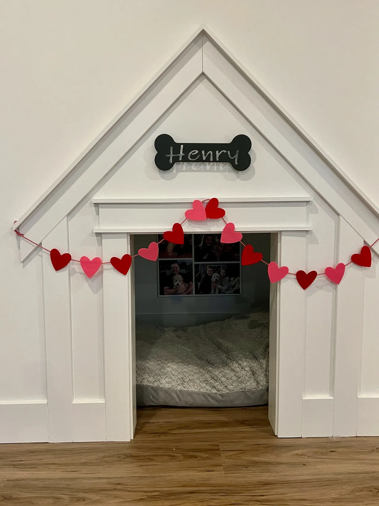 a dog house decorated for valentine 's day with hearts and a bone