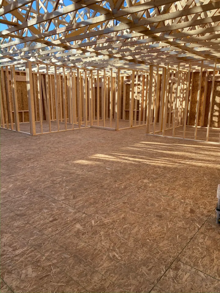 the inside of a house under construction with a lot of wooden beams
