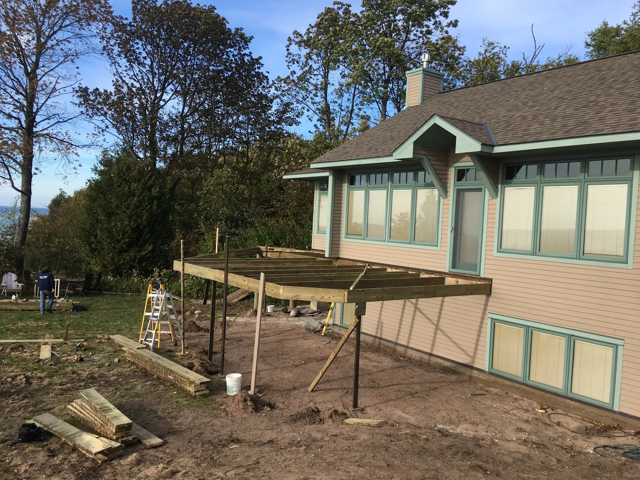 a wooden deck is being built in front of a house